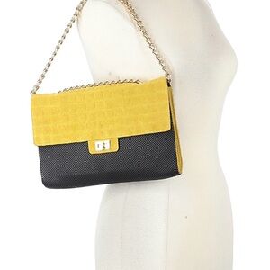 Whiting & Davis yellow suede and black mesh with a gold-tone chain strap.